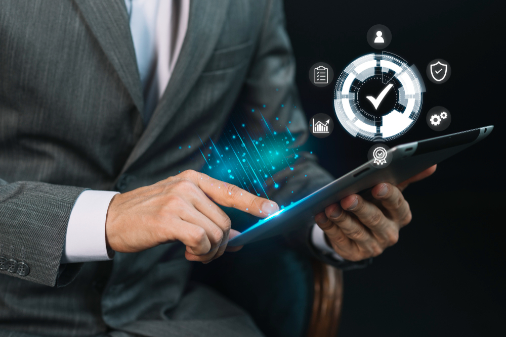 Business professional using a digital tablet with virtual icons representing workflow management, security, analytics, and compliance, highlighting operational efficiency and streamlined business processes.